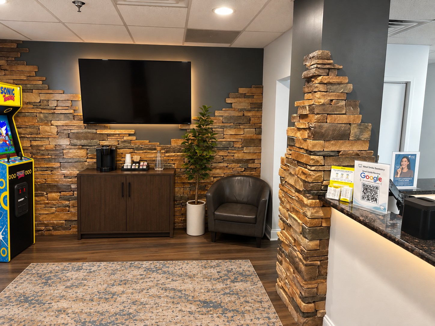Office TV wall and stone columns with the reception desk beyond